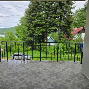 a black fence with a car parked in a yard at Pine Apartments Mavrovo in Mavrovo