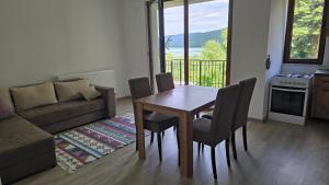 a living room with a table and chairs and a couch at Pine Apartments Mavrovo in Mavrovo