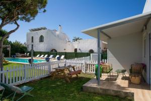 a patio with a table and chairs next to a pool at Apartamentos Zahora 37 in Zahora