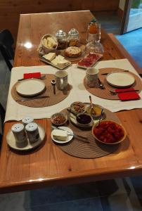a table with plates and bowls of food on it at B&B Court1828 in Lillianes +4 photos