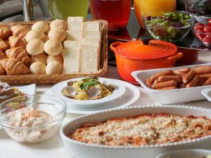 a table topped with different types of food on plates at Premier Hotel-CABIN-Sapporo in Sapporo