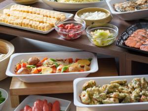 a table filled with different dishes of food at Premier Hotel-CABIN-Sapporo in Sapporo