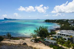 an aerial view of a beach with people in the water at Luxury Beachfront Apartment in Pereybere