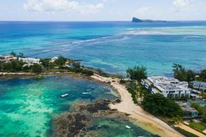 an aerial view of a beach with houses and the ocean at Luxury Beachfront Apartment in Pereybere +56 photos