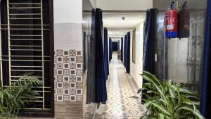 a corridor of a house with plants in the hallway at Ashok Nandini Guest House in Bhubaneshwar
