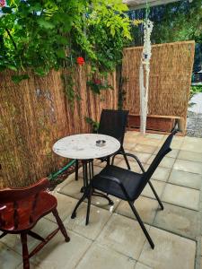 a patio with a table and two chairs and a fountain at Libelloula's apartment google it in Lygia
