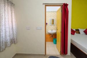 a bathroom with a bed and a sink in a room at Ashok Nandini Guest House in Bhubaneshwar +58 photos