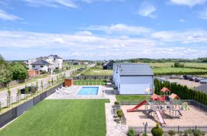 an aerial view of a backyard with a playground at Domki Venus z basenem in Ustronie Morskie