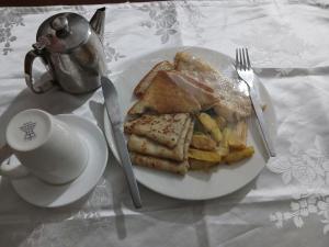 a plate of food with toast and a cup of coffee at Sungura Villa in Nakuru