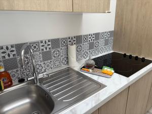 a kitchen counter with a sink and a sink at Appartement rénové, RDC, proche commodités in Armentières