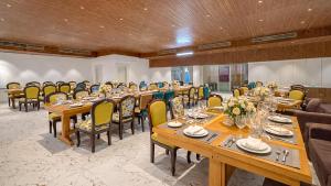 a conference room with wooden tables and chairs at Sumitel Premier Inn in Siliguri