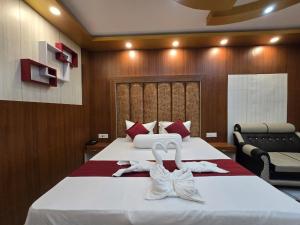 a bedroom with a bed with white towels on it at RESORT SAIKAT SARANYA in Mandarmoni +29 photos