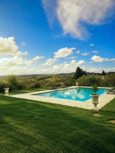 a swimming pool in the middle of a yard at Podere di Montecchio - Le Andane in Tavarnuzze