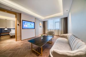 a living room with a couch and a table at Ibis Styles Liyang Shanghecheng in Liyang