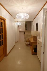 a hallway with two lights and a table and chairs at Casa Lagoa Azul in Foz do Arelho