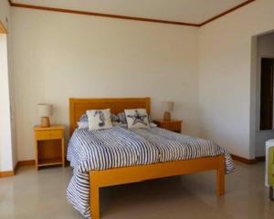 a bedroom with a bed with two pillows on it at Casa Lagoa Azul in Foz do Arelho
