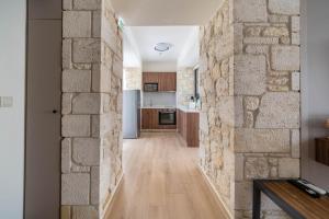 a hallway with a stone wall in a house at The Olive Path in Kalandra