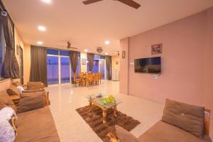 a living room with a couch and a table at ll VIBE WITH US II BIG DADDY VILLA II 6BHK II AC II PRIVATE POOL II in Lonavala