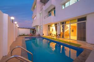 a swimming pool in the backyard of a house at ll VIBE WITH US II BIG DADDY VILLA II 6BHK II AC II PRIVATE POOL II in Lonavala