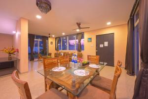 a dining room with a table and chairs at ll VIBE WITH US II BIG DADDY VILLA II 6BHK II AC II PRIVATE POOL II in Lonavala