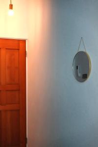 a mirror on a blue wall next to a door at Island River in Green Island