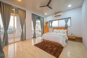 a bedroom with a large bed and large windows at ll VIBE WITH US II BIG DADDY VILLA II 6BHK II AC II PRIVATE POOL II in Lonavala +47 photos