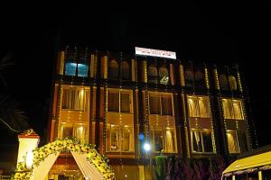a large building with a sign on it at night at Doon Sanskaram Hotel in Chūharpur