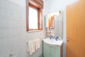 a bathroom with a sink and a mirror at Casette nel Borgo in Borgagne +40 photos