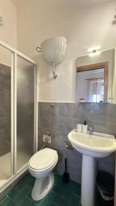 a bathroom with a toilet and a sink and a shower at Villa Cristina in Casteldaccia +71 photos