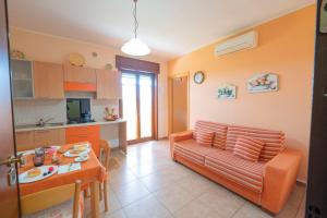 a living room with a couch and a table at Casette nel Borgo in Borgagne