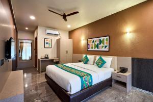 a bedroom with a large bed in a room at Treebo Sky Vista Suites with Hill View in Chikmagalūr +28 photos