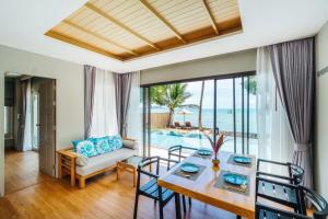 a dining room with a view of the ocean at Fair House Villas & Spa, Koh Samui in Mae Nam