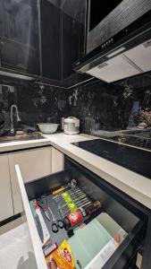 a kitchen with an open refrigerator filled with food at MONO HAUS Villa Danang in Danang