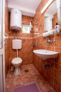 a bathroom with a toilet and a sink at Jadran Apartments in Rafailovici +46 photos