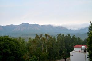 a view of the mountains from a house at Treebo Sky Vista Suites with Hill View in Chikmagalūr