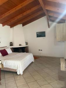 a bedroom with a bed and a tv on the wall at Diarla's Home in Fier
