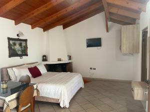 a bedroom with a bed and a table and a fireplace at Diarla's Home in Fier