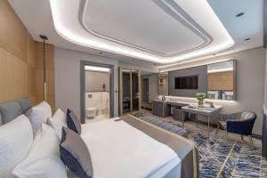 a hotel room with a bed and a bathroom at Altinel Ankara Hotel & Convention Center in Ankara