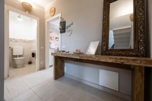 a bathroom with a large mirror and a sink at B&B Benvenuto in Venegono Superiore +32 photos