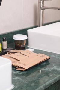 a counter with some brown paper on top of a sink at Souq Beach Hotel فندق سوق الشاطئ in Salalah +46 photos