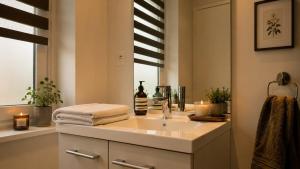 a bathroom with a sink and a window with candles at Oparadi 'L'Authentique' in Wimereux