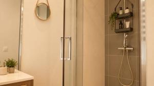 a shower with a glass door in a bathroom at Oparadi 'L'Authentique' in Wimereux