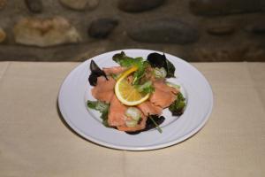 a plate of food with fish and vegetables on a table at Albergo Peluso in Altavilla Irpina