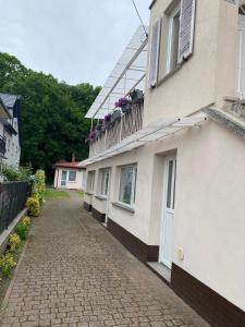 a building with flowers on the side of it at Baltic Garden Stay in Kołobrzeg