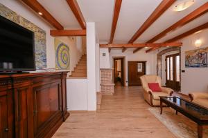a living room with a flat screen tv and a couch at House Polic in Hreljin