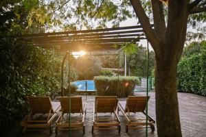 a group of chairs and a table and a tree at House Polic in Hreljin