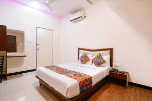 a bedroom with a large bed in a room at FabHotel SK Galaxy in Thane