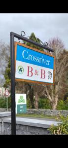 a sign for a bus stop with a sign for a dinosaursteensteensteensteen at Crossriver B&B in Oughterard