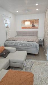 a living room with a bed and a couch at LinnankadunHelmi in Savonlinna