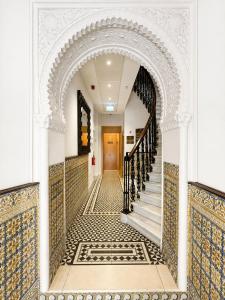 an archway leading up to a staircase in a building at Grand Central House - Classic Studio - GibraltarStay Apartments in Gibraltar